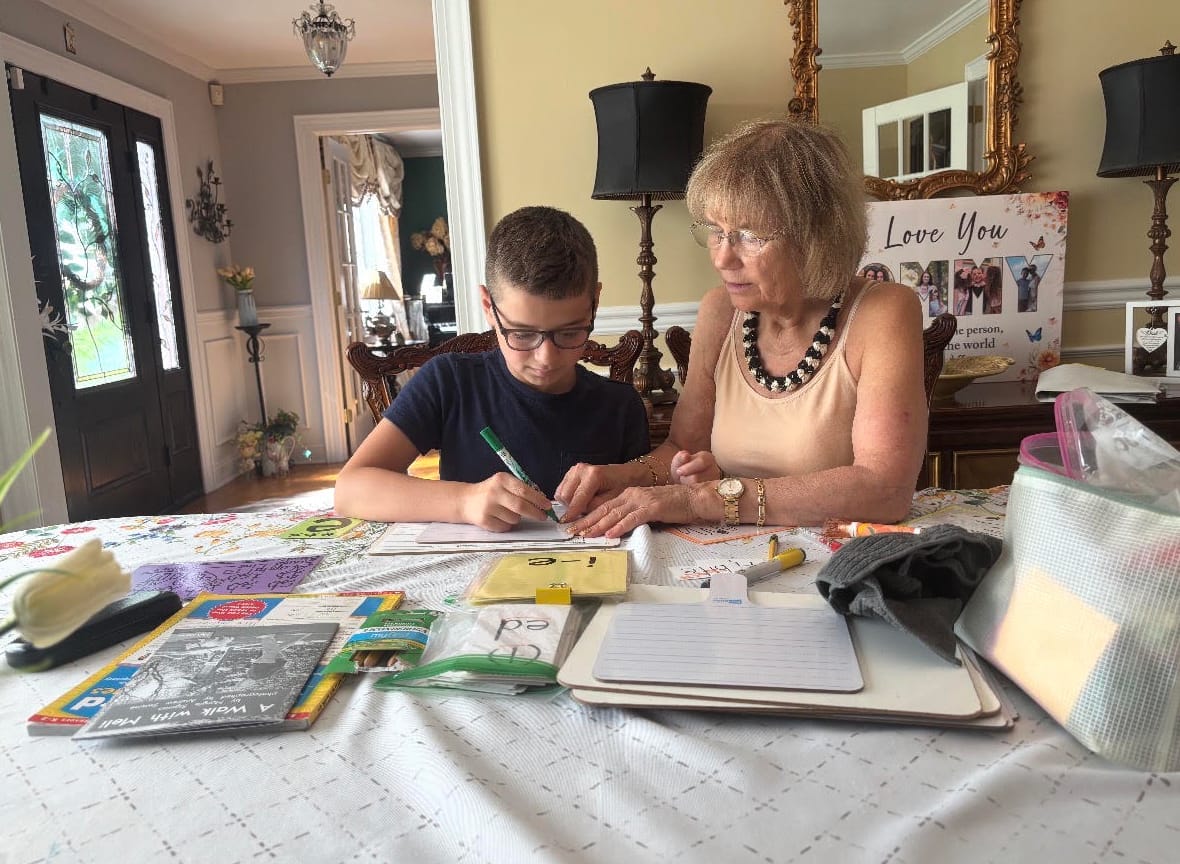 One-on-one reading tutoring session with structured literacy materials