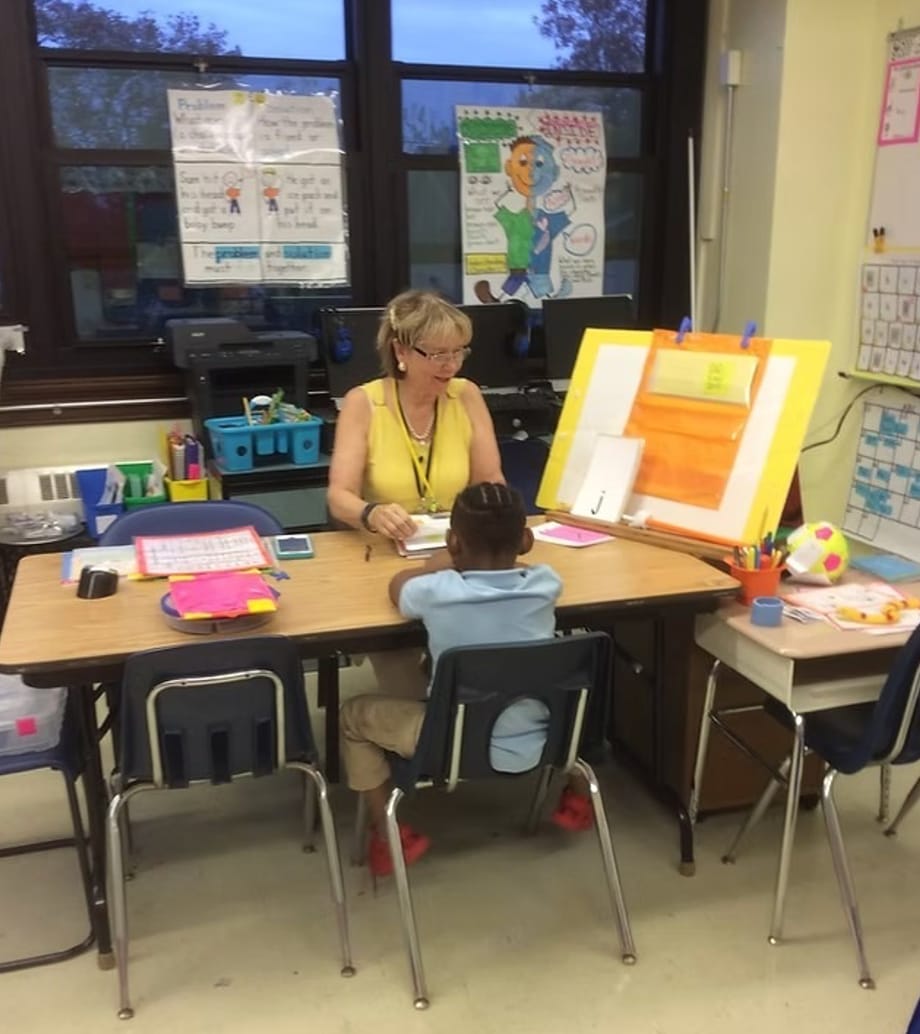 Patricia working one-on-one with a young student at a lesson easel